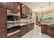 The kitchen showcases dark wood cabinets, granite counters, and stainless steel appliances at 12240 Thornhill Ct, Lakewood Ranch, FL 34202