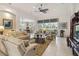 Bright living room with tile floors, a ceiling fan and comfortable seating arrangement at 12240 Thornhill Ct, Lakewood Ranch, FL 34202