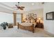 Tranquil main bedroom with a tray ceiling, neutral colors, and carpeted floors at 12240 Thornhill Ct, Lakewood Ranch, FL 34202
