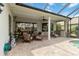 Spacious patio with comfortable seating, summer kitchen, lush landscaping, and access to the inviting pool at 12240 Thornhill Ct, Lakewood Ranch, FL 34202