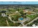 An aerial view of recreational facilities including tennis courts, baseball diamonds, and community sports parks at 1227 Waterside Ln, Venice, FL 34285