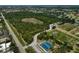 An aerial view of wooded areas as well as tennis and baseball recreational areas at 1227 Waterside Ln, Venice, FL 34285