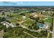 An aerial view of recreational facilities including tennis courts, baseball diamonds, and community sports parks at 1227 Waterside Ln, Venice, FL 34285