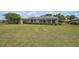 Large backyard featuring a screened-in patio area with views of the yard at 1227 Waterside Ln, Venice, FL 34285