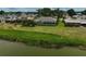Waterfront home featuring a screened-in patio and lush landscaping at 1227 Waterside Ln, Venice, FL 34285