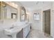 Bathroom includes a pedestal sink, framed mirror, and step-in shower at 1227 Waterside Ln, Venice, FL 34285