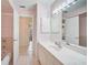 Bathroom features a single vanity with marble countertop, tiled floor and shower-tub combo at 1227 Waterside Ln, Venice, FL 34285