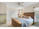 Bedroom with ceiling fan and neutral walls; natural light from two windows at 1227 Waterside Ln, Venice, FL 34285