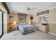 Bedroom boasts a ceiling fan, neutral paint, tile floors and closet at 1227 Waterside Ln, Venice, FL 34285
