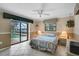 Bedroom overlooking the pool with a ceiling fan, tile floors and closet at 1227 Waterside Ln, Venice, FL 34285