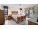 Bedroom includes a ceiling fan, tile floors, closet, dresser and outdoor view at 1227 Waterside Ln, Venice, FL 34285