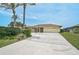 A home with a concrete driveway and a well-maintained lawn at 1227 Waterside Ln, Venice, FL 34285
