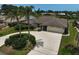 Single-story home boasting an attached two-car garage, circular driveway, and well-manicured landscaping at 1227 Waterside Ln, Venice, FL 34285
