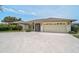 Single-story home with an attached two-car garage and a large driveway with ample parking at 1227 Waterside Ln, Venice, FL 34285