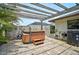 Backyard hot tub area featuring a wooden pergola for shade at 1227 Waterside Ln, Venice, FL 34285