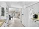 Bright kitchen featuring white appliances, tiled floors and a view into the living space at 1227 Waterside Ln, Venice, FL 34285