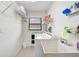 Functional laundry room with sink, washer and dryer, and storage shelves at 1227 Waterside Ln, Venice, FL 34285