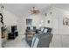 Spacious living room with neutral colors, ceiling fan, and comfortable leather furniture at 1227 Waterside Ln, Venice, FL 34285
