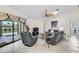 Cozy living room featuring tiled floors, comfortable seating, and views of the pool area at 1227 Waterside Ln, Venice, FL 34285