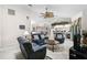 Open concept living room with tiled floor, ceiling fan, and view into kitchen area at 1227 Waterside Ln, Venice, FL 34285