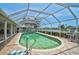 Relaxing screened-in pool with brick surround and view of the water at 1227 Waterside Ln, Venice, FL 34285