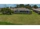 An aerial view of a home's screened-in pool and landscaped backyard at 1227 Waterside Ln, Venice, FL 34285