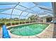 Inviting in-ground pool with a screened-in enclosure and brick paver deck at 1227 Waterside Ln, Venice, FL 34285