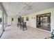 Large sunroom features tiled floors, ceiling fans, furniture and sliding glass doors at 1227 Waterside Ln, Venice, FL 34285