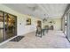 Spacious sunroom boasts tiled floors, ceiling fans, and sliding glass doors at 1227 Waterside Ln, Venice, FL 34285