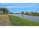 Waterfront view showcasing the serene lake and surrounding homes at 1227 Waterside Ln, Venice, FL 34285