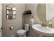 Cozy half bath with a pedestal sink, decorative mirror, and stylish accents for added convenience at 13706 American Prairie Pl, Lakewood Ranch, FL 34211