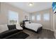 Comfortable bedroom with large windows providing natural light, plus a sofa for lounging at 13706 American Prairie Pl, Lakewood Ranch, FL 34211