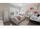 Stylish bedroom with a bright window, modern furniture, and decorative accents at 13706 American Prairie Pl, Lakewood Ranch, FL 34211