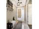 Bright entryway features tile flooring, neutral walls, and a decorative shelf with hooks, creating a welcoming atmosphere at 13706 American Prairie Pl, Lakewood Ranch, FL 34211