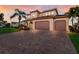 Charming home with a tile roof, three-car garage, and paved driveway at 13706 American Prairie Pl, Lakewood Ranch, FL 34211