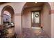 Inviting front porch with stylish seating and an elegant front door with decorative wreath at 13706 American Prairie Pl, Lakewood Ranch, FL 34211