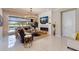 Open-concept living area with modern fireplace, elegant lighting, and seamless flow to screened lanai and pool at 13706 American Prairie Pl, Lakewood Ranch, FL 34211