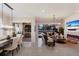 Open-concept living and dining area with elegant lighting, fireplace, and seamless flow to screened lanai at 13706 American Prairie Pl, Lakewood Ranch, FL 34211