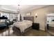 Spacious main bedroom with sitting area, tray ceilings, and large windows providing ample natural light at 13706 American Prairie Pl, Lakewood Ranch, FL 34211