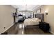 Large main bedroom with tray ceilings, wood floors, sitting area, and serene atmosphere at 13706 American Prairie Pl, Lakewood Ranch, FL 34211
