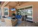 Relaxing patio featuring comfortable seating, television, ceiling fan, and a view of the pool at 13706 American Prairie Pl, Lakewood Ranch, FL 34211