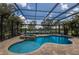 Enclosed pool and spa overlooking a serene lake, perfect for relaxing and enjoying the outdoors at 13706 American Prairie Pl, Lakewood Ranch, FL 34211