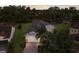 Aerial view of home showcasing its manicured surroundings, mature trees, and a well-maintained tile roof at 13848 American Prairie Pl, Lakewood Ranch, FL 34211