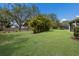 Well-manicured backyard featuring mature trees and landscaping, perfect for recreation at 13848 American Prairie Pl, Lakewood Ranch, FL 34211