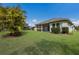 Expansive backyard with lush green lawn and a screened lanai, ideal for outdoor enjoyment at 13848 American Prairie Pl, Lakewood Ranch, FL 34211