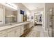 Spacious bathroom with double sinks, extensive counter space and tile-surround walk-in shower at 13848 American Prairie Pl, Lakewood Ranch, FL 34211