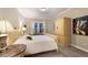 Calm bedroom featuring bed with decorative pillows, side tables with lamps, and wardrobe at 13848 American Prairie Pl, Lakewood Ranch, FL 34211