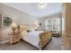 Spacious bedroom suite with comfortable bed, sitting area, and lots of natural light at 13848 American Prairie Pl, Lakewood Ranch, FL 34211