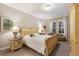 Serene bedroom featuring a comfortable bed, side tables with lamps, and ample natural light at 13848 American Prairie Pl, Lakewood Ranch, FL 34211