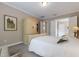 Calming bedroom featuring carpet, comfortable bed, and access to en-suite bathroom at 13848 American Prairie Pl, Lakewood Ranch, FL 34211